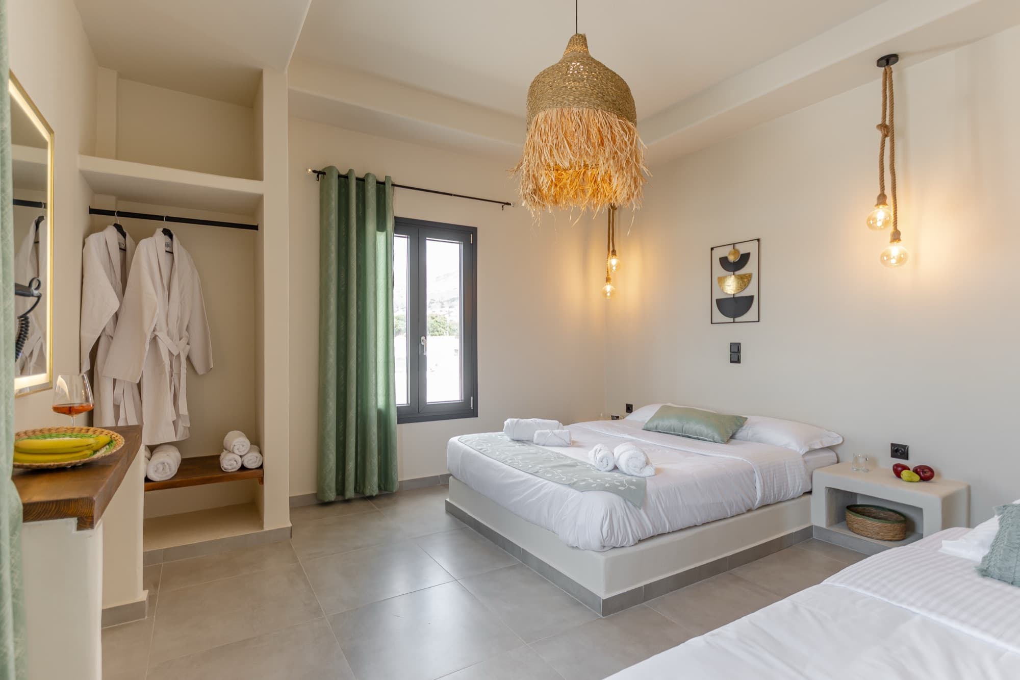 Bedroom with open closet, bathrobes and woven pendant lighting