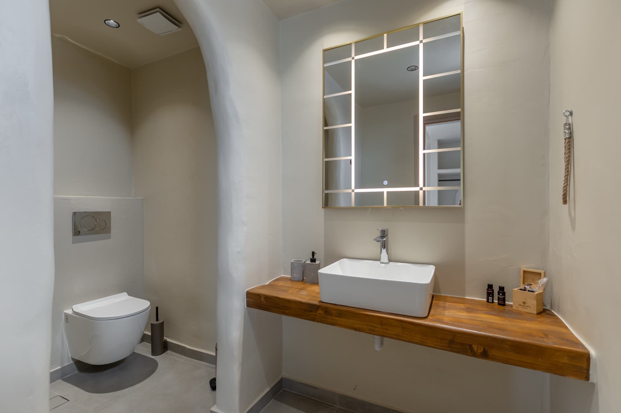Cave-style bathroom with arched vault ceiling and rain shower