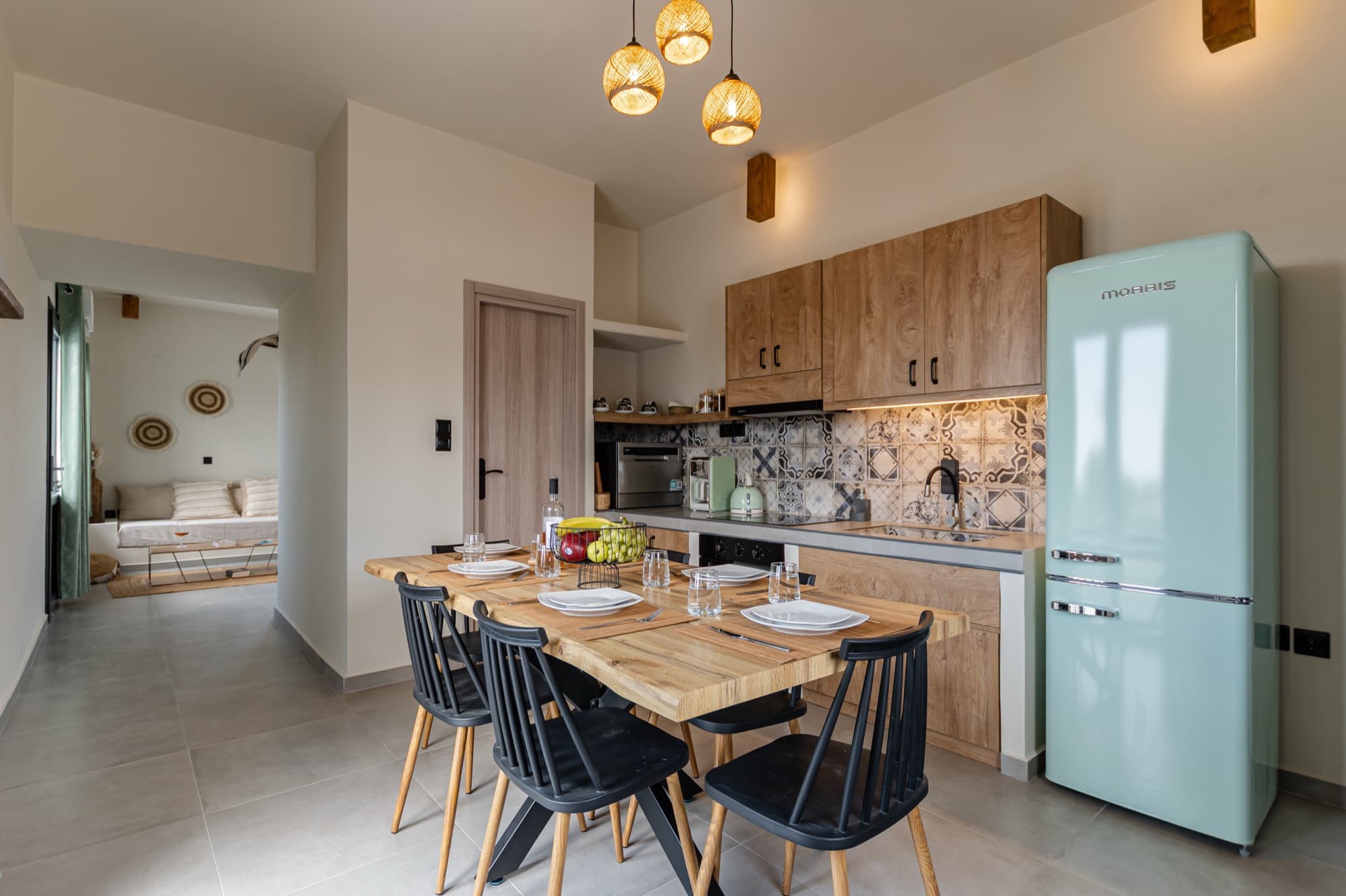Villa Eira kitchen with rustic wooden cabinets, patterned backsplash and retro fridge