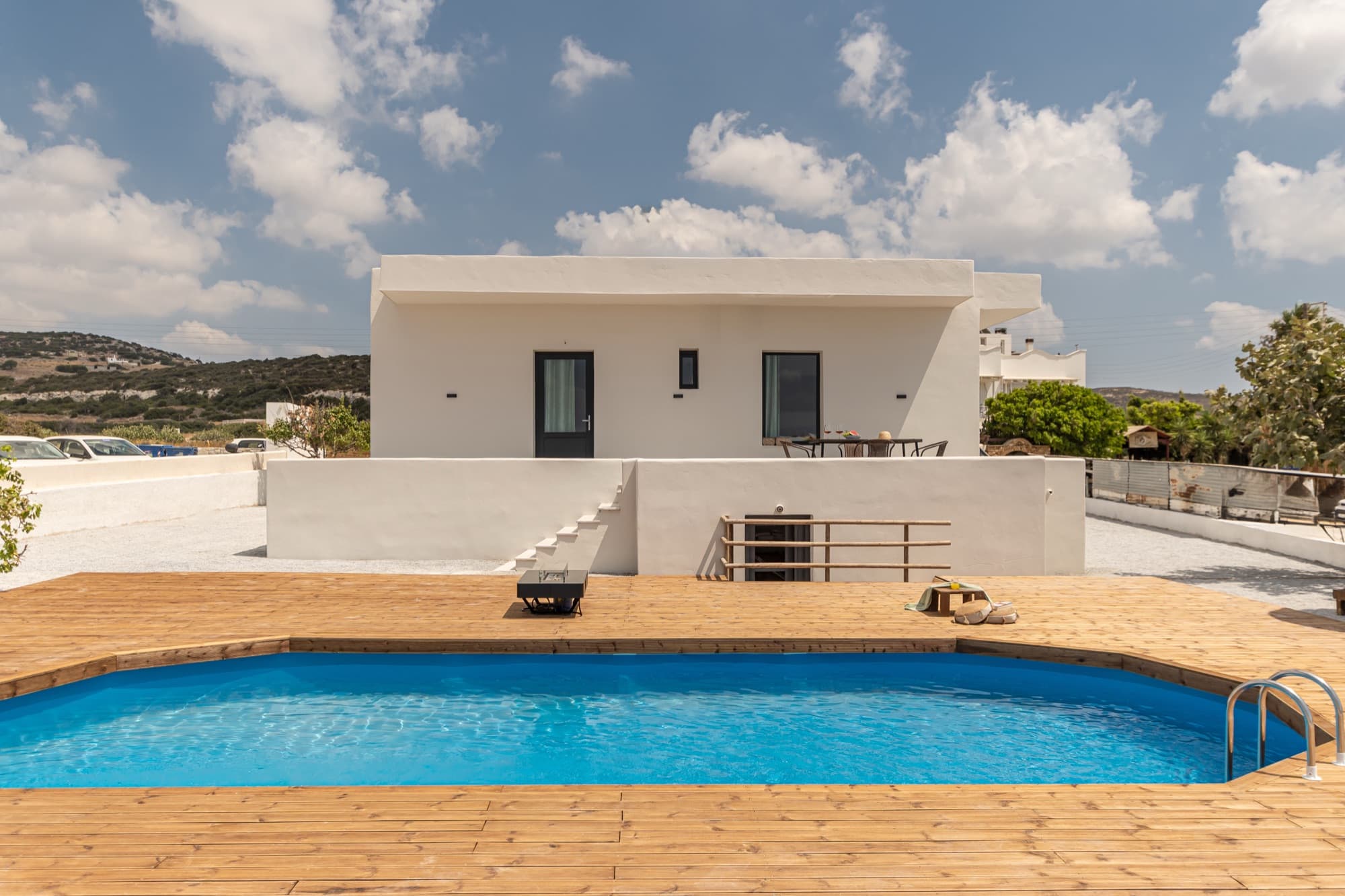 Villa Eira exterior view from poolside with white Cycladic architecture